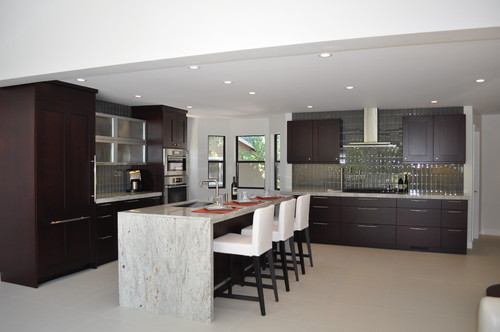 River White Granite Countertop, River White Waterfall Edge Overhang Island Top, Wineberry Stained Walnut Cabinets, Aluminum Framed Glass Cabinet Door, Imitated Travertine Porcelain Flooring , Stainless Steel Appliance and Stainless Steel Hood